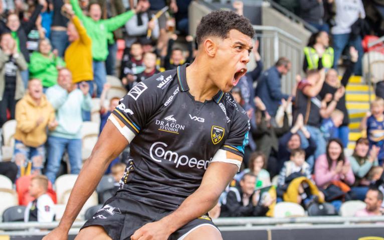 Rio Dyer celebrates a try for Dragons