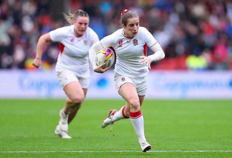 Abby Dow of England runs with the ball