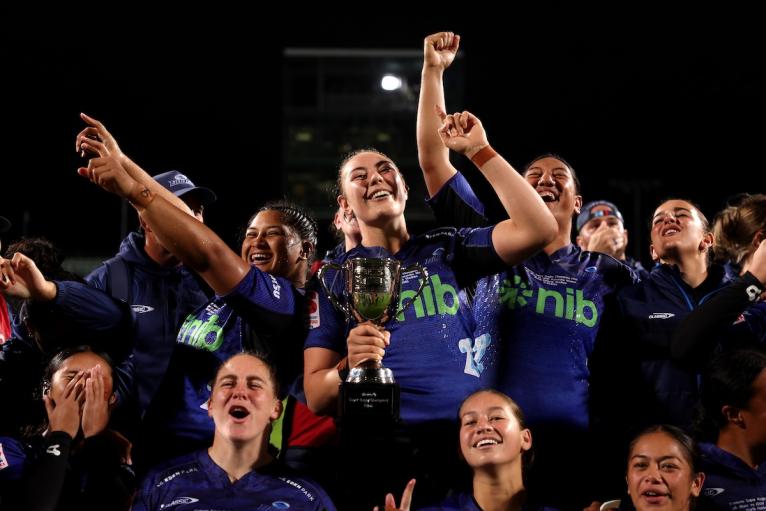 Maiakawanakaulani Roos of the Blues celebrates with her team after winning the 2025 Women's Super Rugby Champions Final 