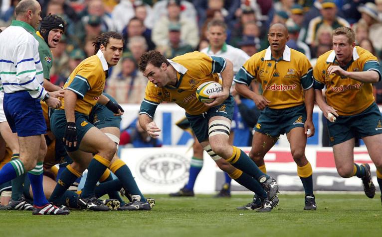Owen Finegan carries the ball for Australia against South Africa in 2002