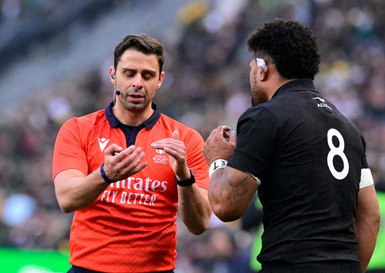 Referee Nika Amashukeli speaks to NZ captain Ardie Savea