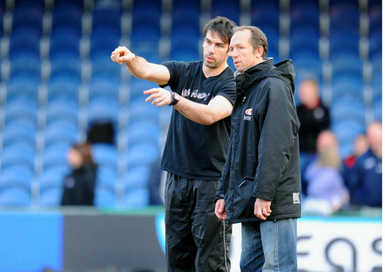 Alex Sanderson makes a point to Brendan Venter