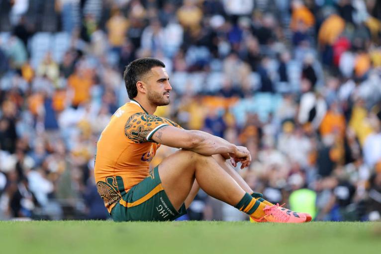 Tom Wright sits alone on the pitch after Australia's defeat in Sydney