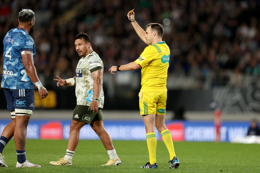 Ash Dixon of the Highlanders is shown a yellow card